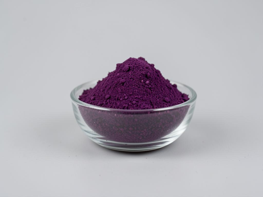 Acai Berry Powder shown as a fine dried fruit or vegetable powder in a shallow dish in a neutral studio photograph