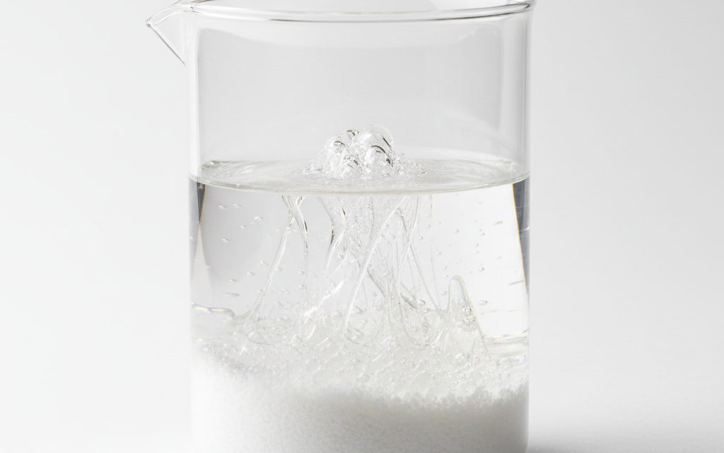 Grade confirmed at quotation — white, free-flowing granular powder or tiny translucent beads; dissolves into a clear, highly viscous, slippery, and stringy mucilage, studio product photograph