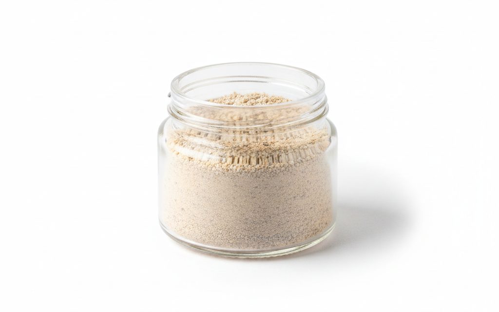 Grade confirmed at quotation — earth-toned cream to greyish fine powder or small granules with a soft, clay-like texture that swells significantly when hydrated, studio product photograph