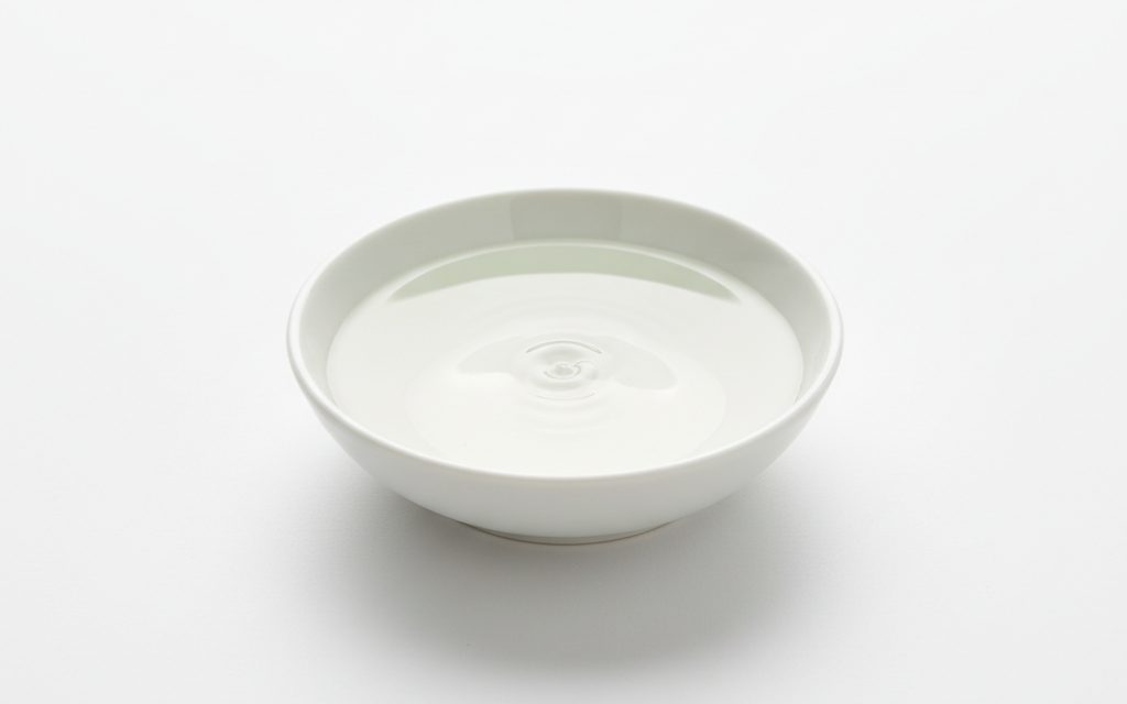 Grade confirmed at quotation — clear, colorless oily liquid with a mild pleasant aromatic odor and low volatility at standard room temperatures, studio product photograph