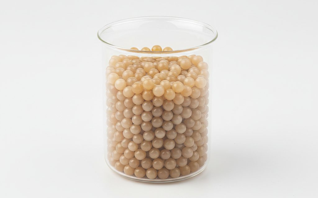 Grade confirmed at quotation — uniform resin-based pellets, typically translucent or beige, with a firm texture and smooth exterior for efficient melt processing, studio product photograph