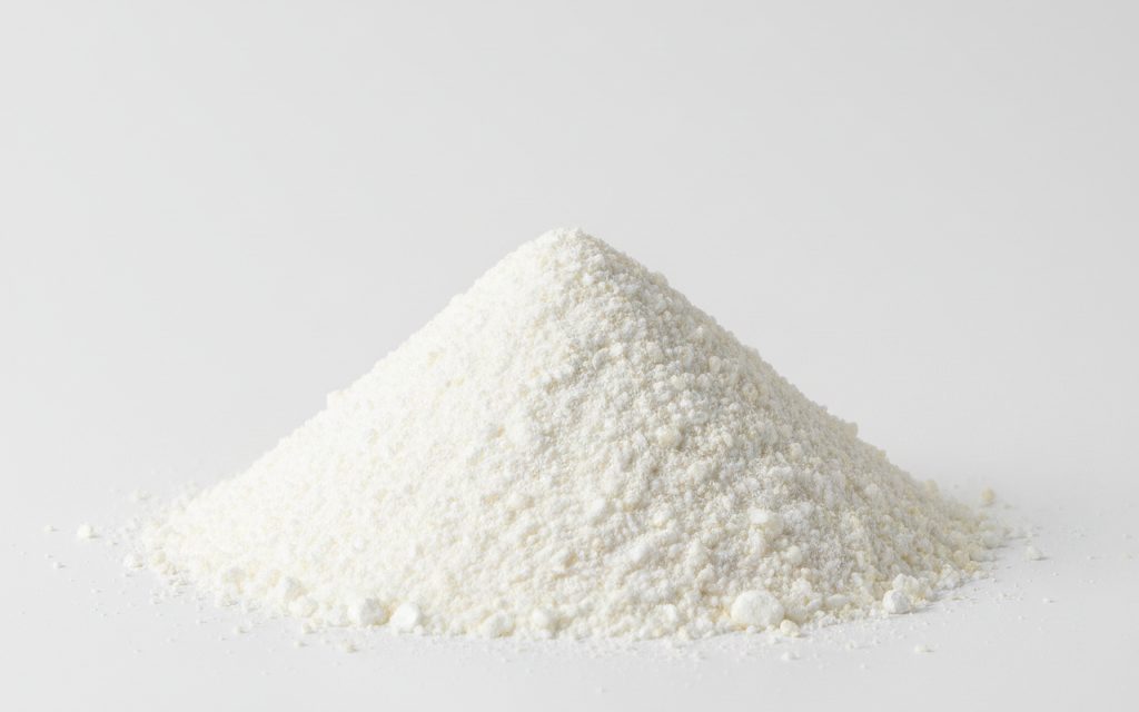 Calcium Formate — white to off-white crystalline granules or powder with a slight vinegar-like odor and excellent flowability for dry-mix applications, studio product photograph