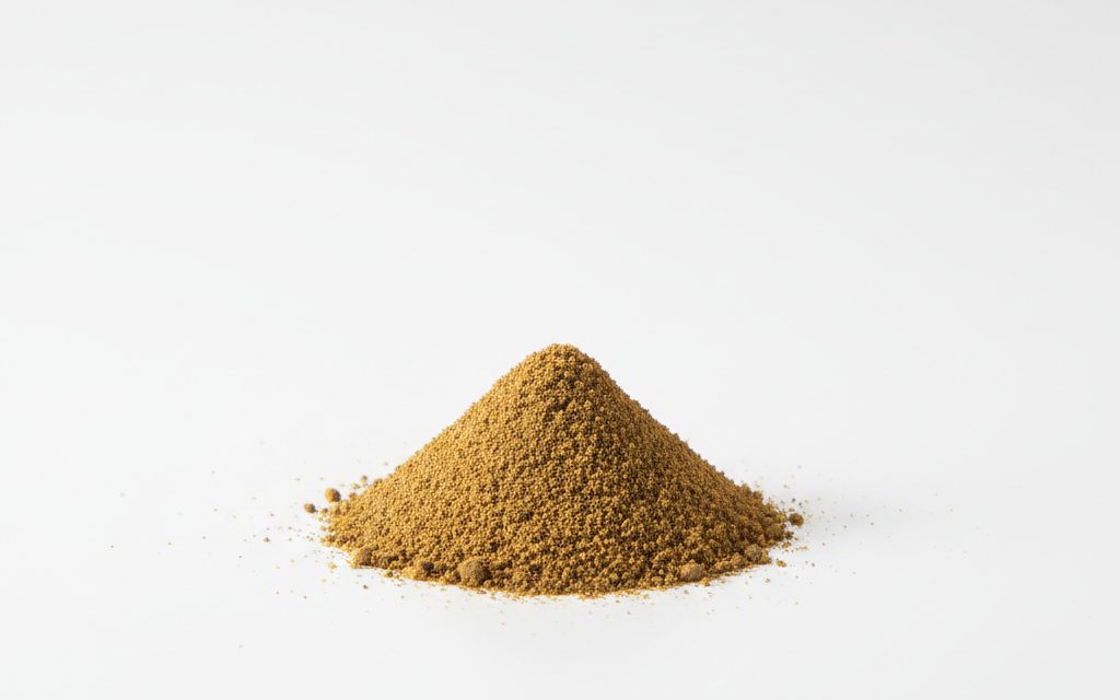 Calcium Lignosulphonate — yellow-brown to dark brown fine powder, appearing as a dry, organic, and slightly sticky solid in a lab dish, studio product photograph
