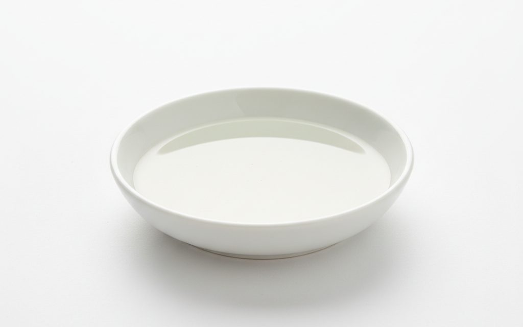 Grade confirmed at quotation — a clear, colorless, very low-viscosity oily liquid that is odorless and non-greasy to the touch, studio product photograph