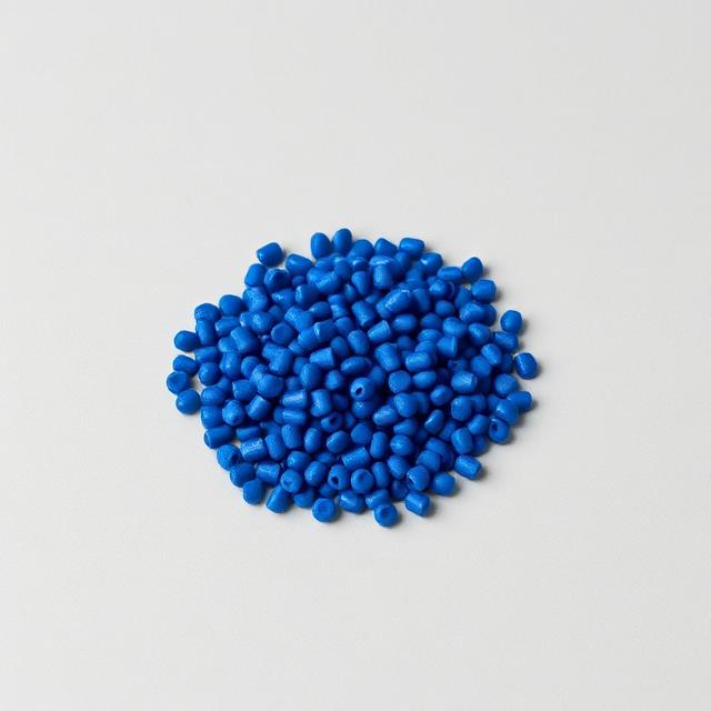 Deep blue colour masterbatch pellets shown as a neutral studio product photograph