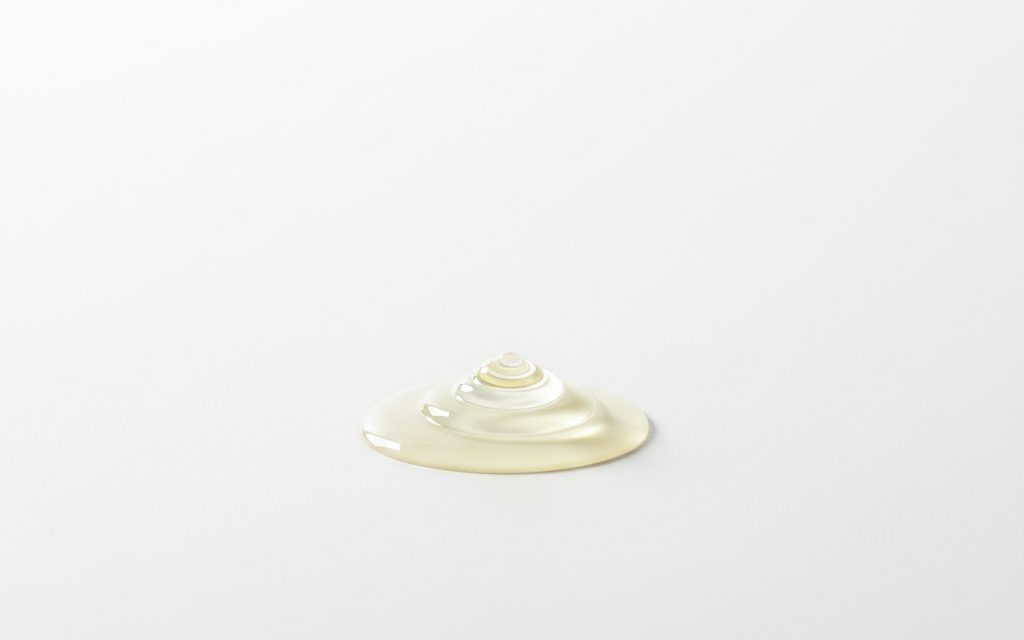 Grade confirmed at quotation — clear to pale yellow, thin aqueous liquid with a mild odor, showing low viscosity and complete solubility in water, studio product photograph