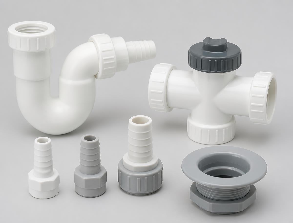 White and grey plastic HVAC condensate fittings including a P-trap, a clean-out tee, hose adapters and a drain pan outlet