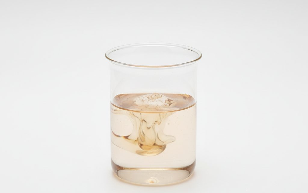 Grade confirmed at quotation — viscous clear to light brown liquids, often possessing a mild chemical scent, supplied for industrial scale water system dosing, studio product photograph
