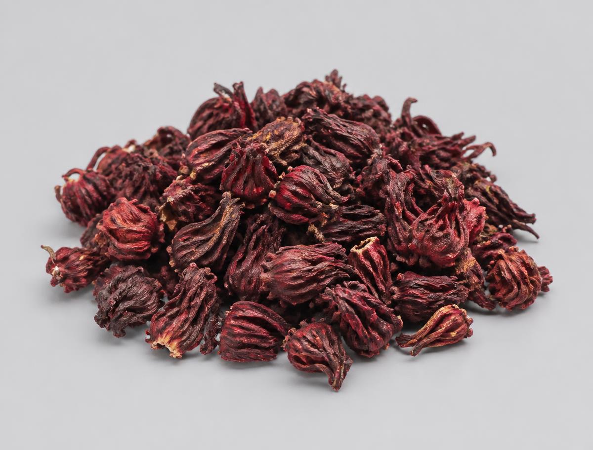 Dried Hibiscus Flowers — studio photograph of whole deep-crimson dried roselle calyces as supplied in bulk