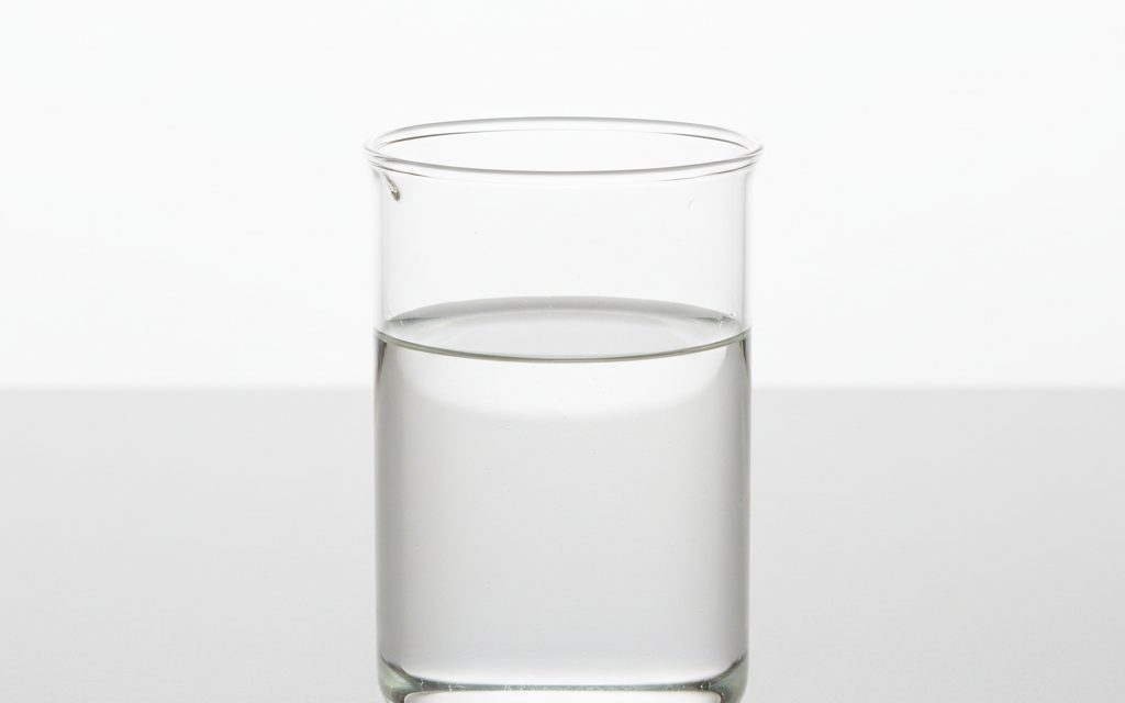 Grade confirmed at quotation — clear, colorless to pale straw-colored liquid with a characteristic odor, used as a high-purity liquid additive, studio product photograph