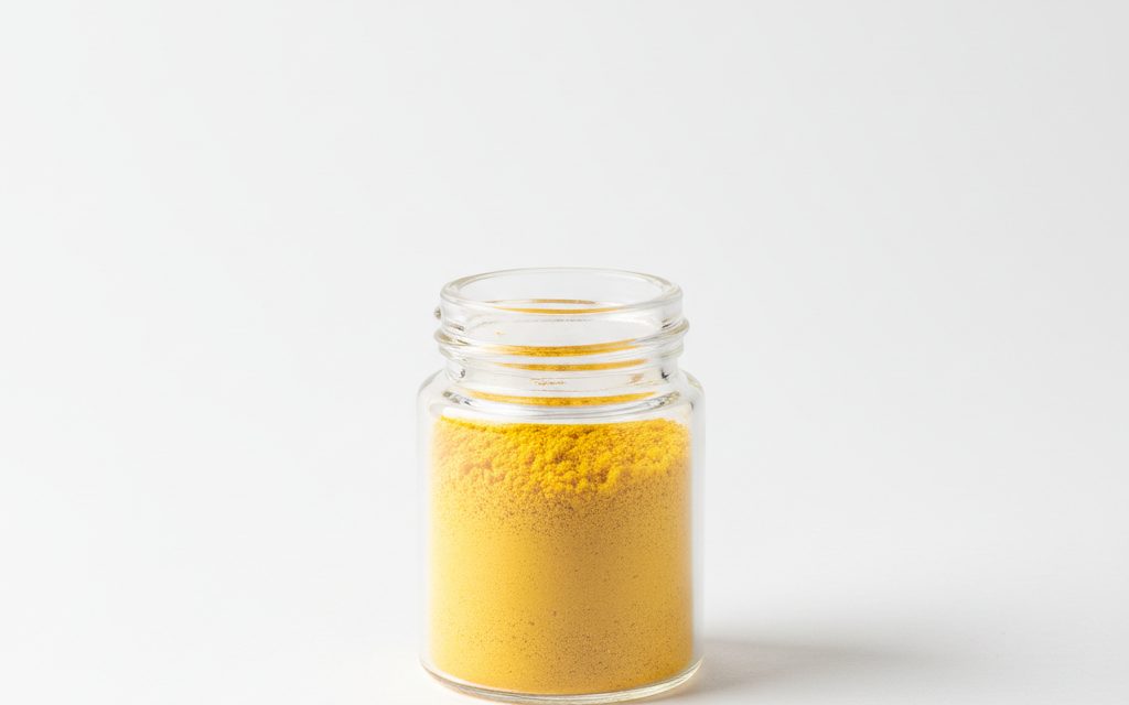Folic Acid — yellow to orange-yellow fine crystalline powder, appearing as a dense, dry, and brightly colored solid in a lab dish, studio product photograph