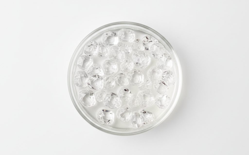 Grade confirmed at quotation — translucent colorless crystals or a clear aqueous solution, odorless and highly acidic, typically handled in corrosion-resistant industrial packaging, studio product photograph