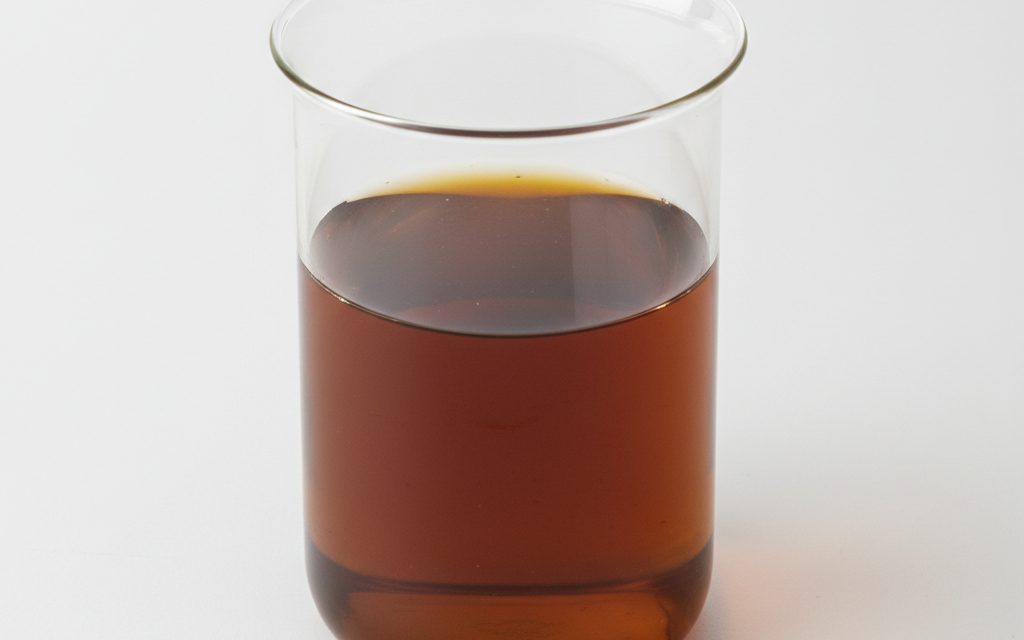 Grade confirmed at quotation — an amber to dark brown aqueous liquid with a characteristic proteinaceous odor, usually clear to slightly cloudy, studio product photograph
