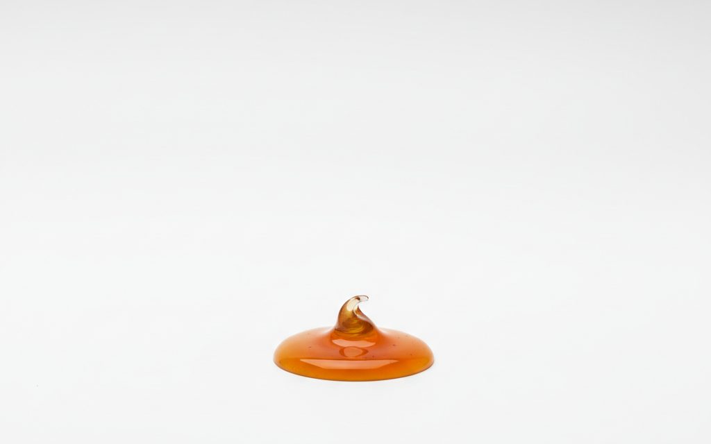 Grade confirmed at quotation — an amber to light brown liquid with a mild, characteristic odor, typically supplied as a 20-25% solution, studio product photograph