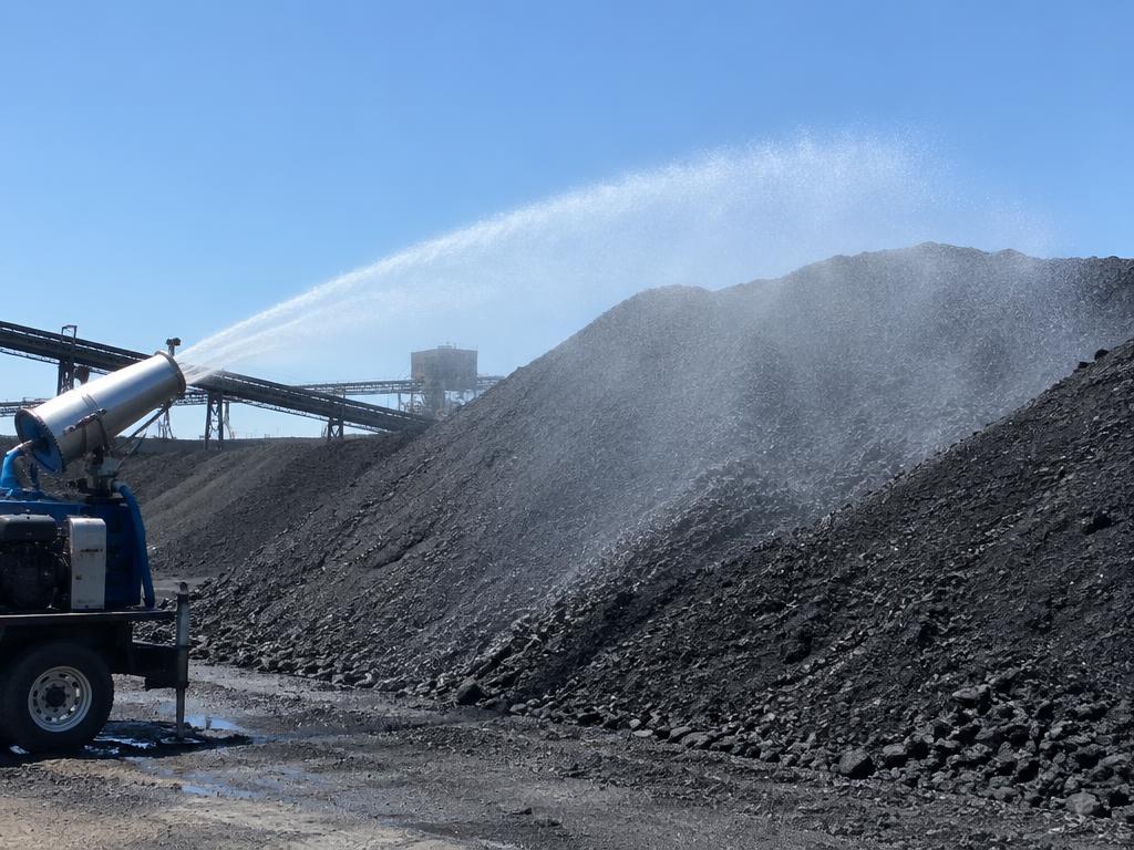 Dust suppression spray over a coal stockpile — generic product illustration