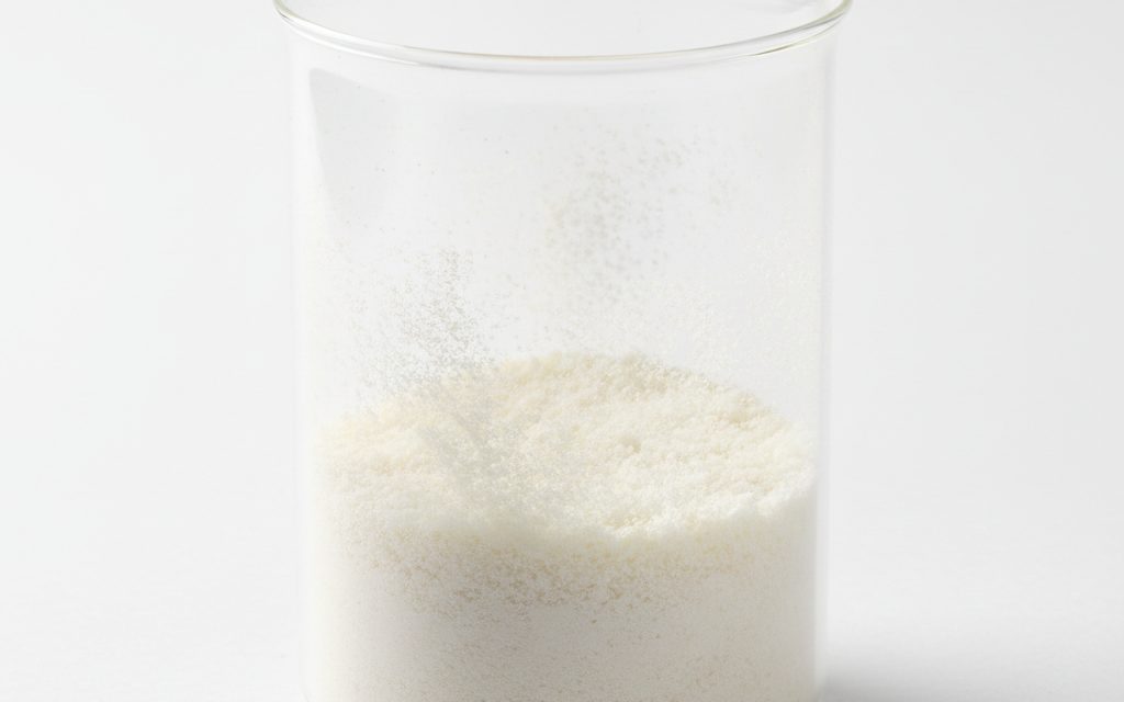 L-Tryptophan — white to yellowish-white crystalline powder or thin flakes, odorless to slightly bitter, and exhibiting a very fine, light texture, studio product photograph