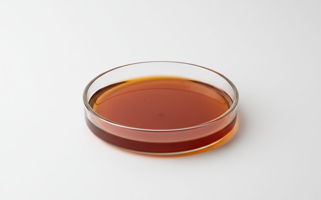 Mixed Tocopherols — a viscous, brownish-red oily liquid with a mild, characteristic vegetable oil aroma, often presented in clear glass vials, studio product photograph