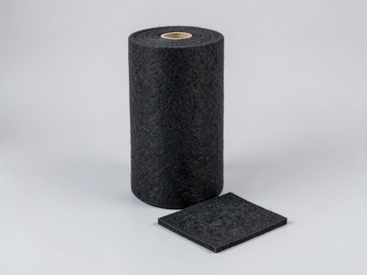 Charcoal needlepunched polyester nonwoven felt roll with a cut sample piece