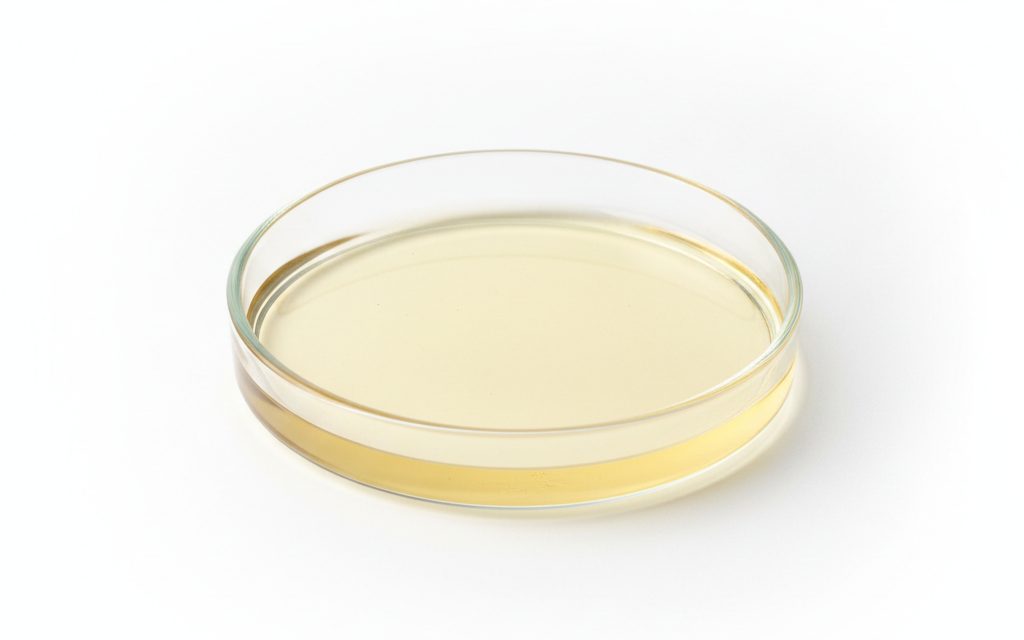 Grade confirmed at quotation — clear, pale yellow to amber aqueous liquid; typically a low-viscosity solution with a slight chemical odor in beakers, studio product photograph