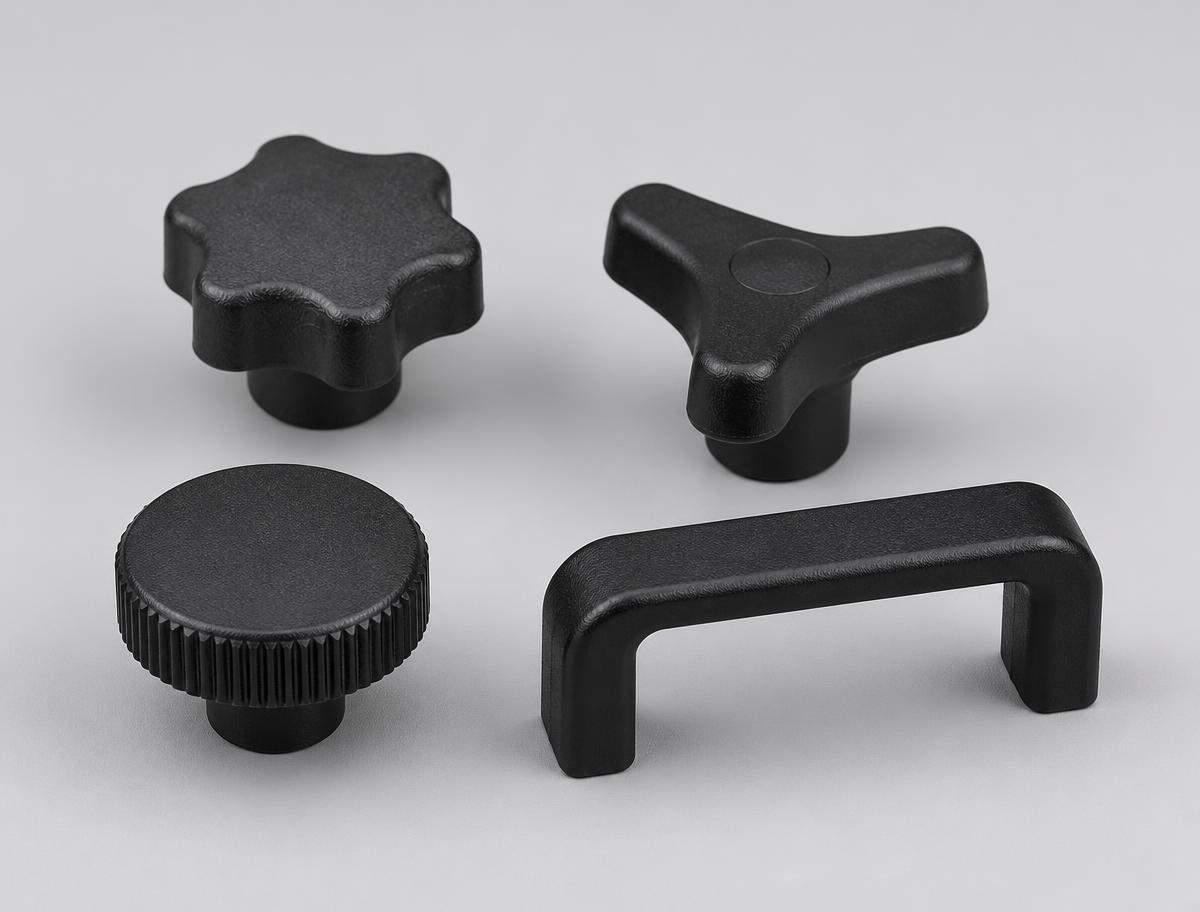 Black moulded star knob, three-lobe clamping knob, knurled round knob and bridge handle shown together