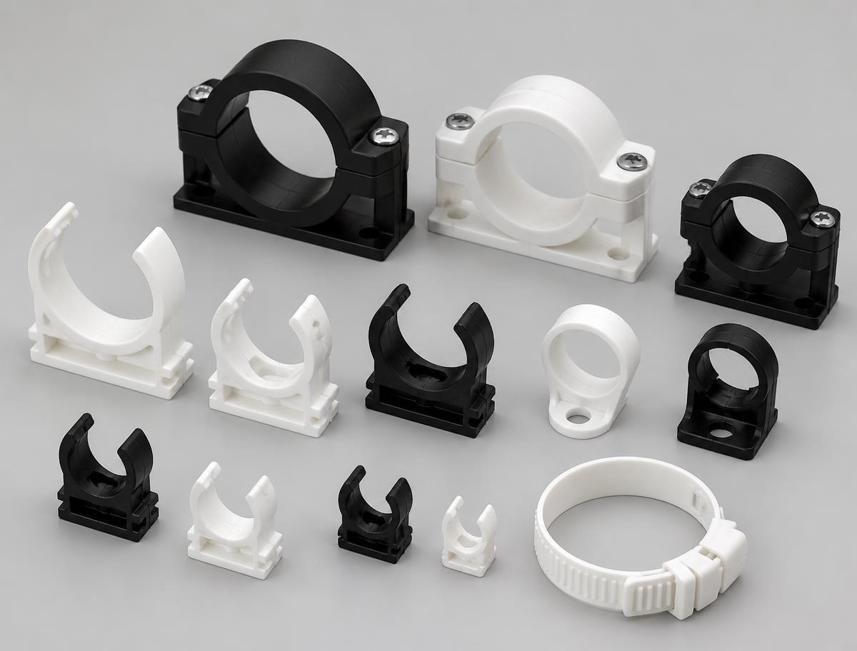 White and black plastic snap-in pipe clips, two-piece tube clamps and a non-metallic hose clamp in several bore sizes