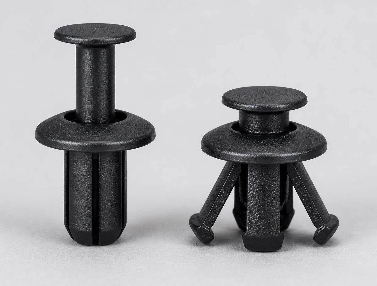 Two black nylon expansion rivets side by side, one with the centre pin raised and legs closed, one with the pin driven home and legs splayed