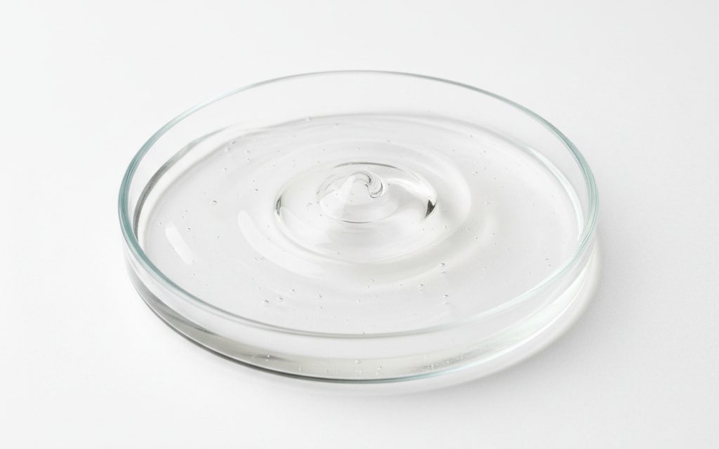 Grade confirmed at quotation — a thick, clear, colorless to slightly hazy aqueous gel-like liquid with high slip and viscosity, studio product photograph