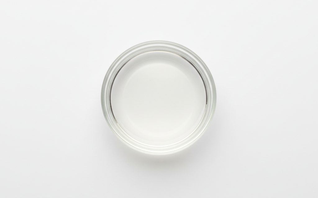 Grade confirmed at quotation — a clear, colorless, odorless, and completely transparent liquid with a low viscosity and slight sweetness, studio product photograph
