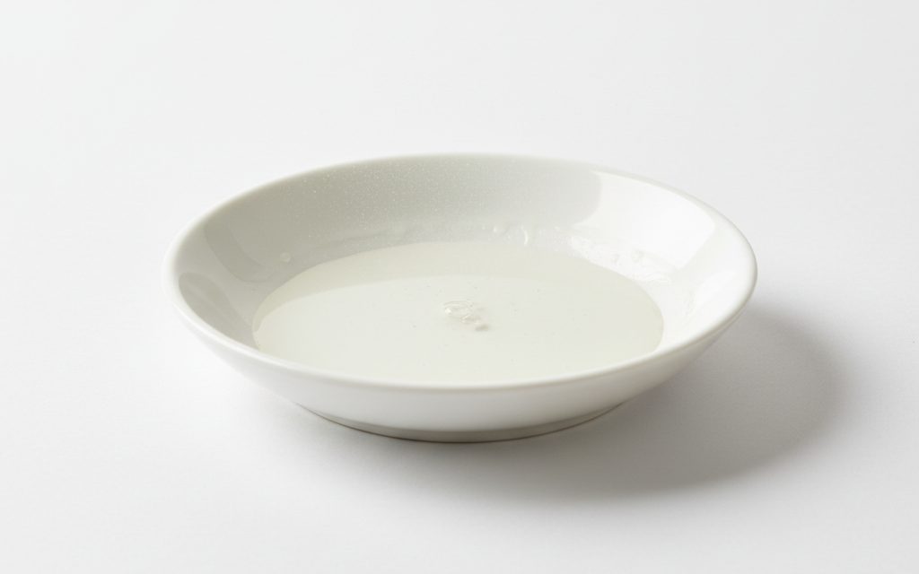 Grade confirmed at quotation — transparent, colorless oily liquid or fine mist spray that leaves a slippery, non-reactive film with high thermal stability on surfaces, studio product photograph