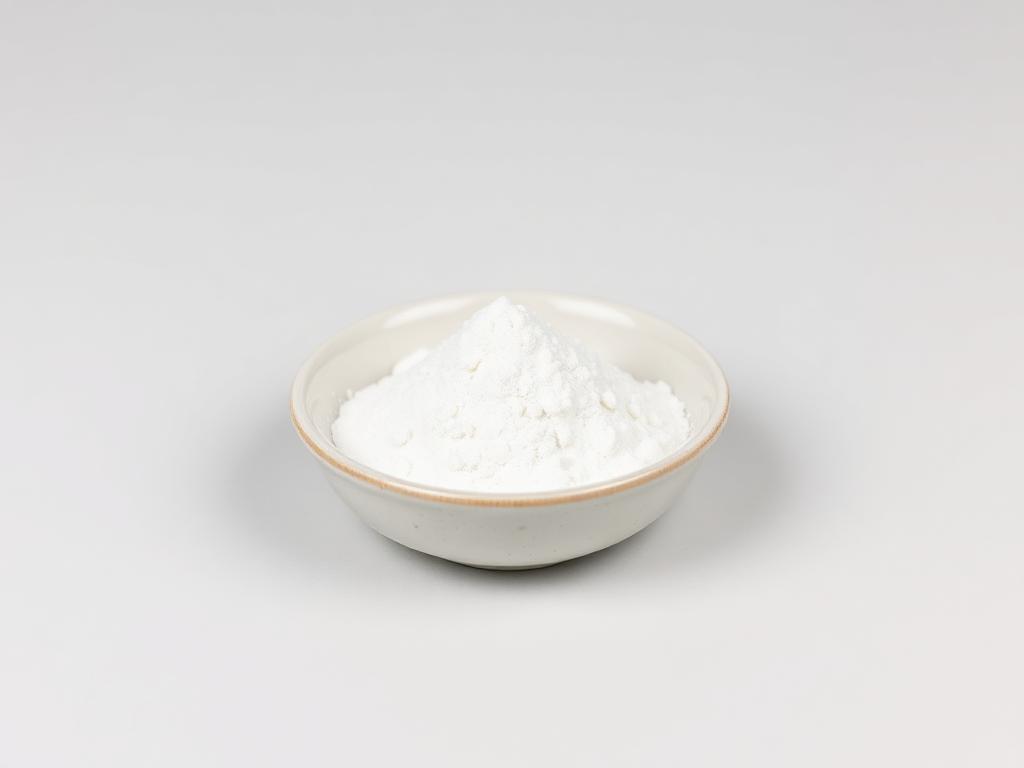 Sodium Caseinate shown as a neutral studio product photograph of the bulk material