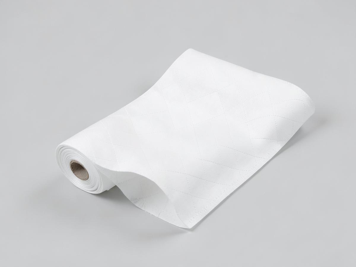 White spunbond polyester nonwoven fabric roll showing a point-bonded surface pattern
