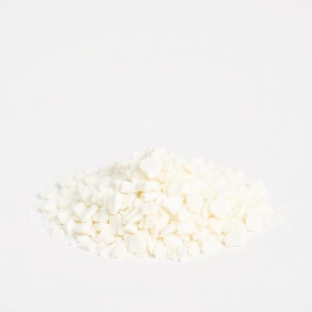 Industrial stearic acid flakes shown as a neutral studio product photograph