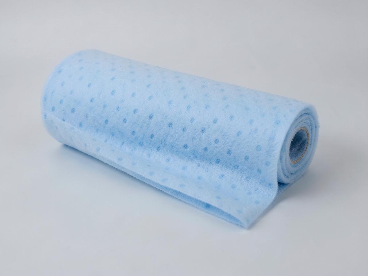 Light blue thermally bonded nonwoven fabric roll with an embossed calendered dot pattern