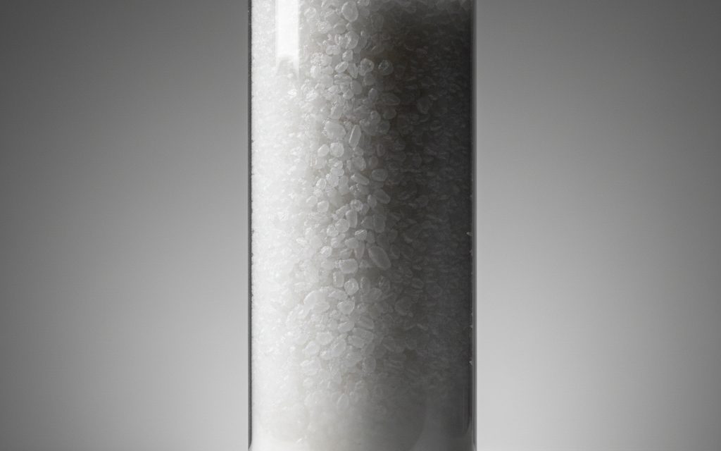 Grade confirmed at quotation — white crystalline prills or powder, slightly hygroscopic with a faint ammonia odor, easily soluble in water and alcohol, studio product photograph