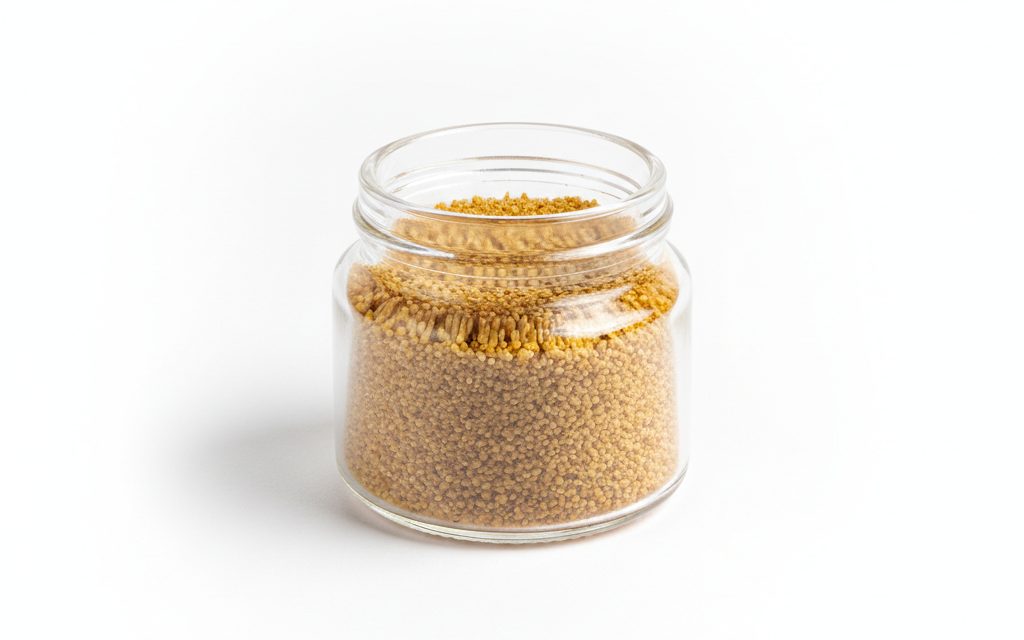 Vitamin D3 — fine yellowish-brown beadlets or dry crystalline powder, characterized by a uniform particle distribution and a non-greasy surface texture, studio product photograph