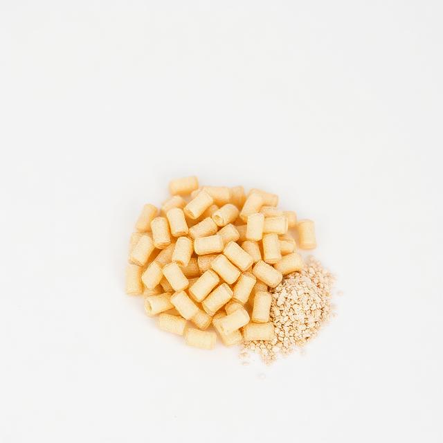 WPC coupling agent pellets with wood flour shown as a neutral studio product photograph