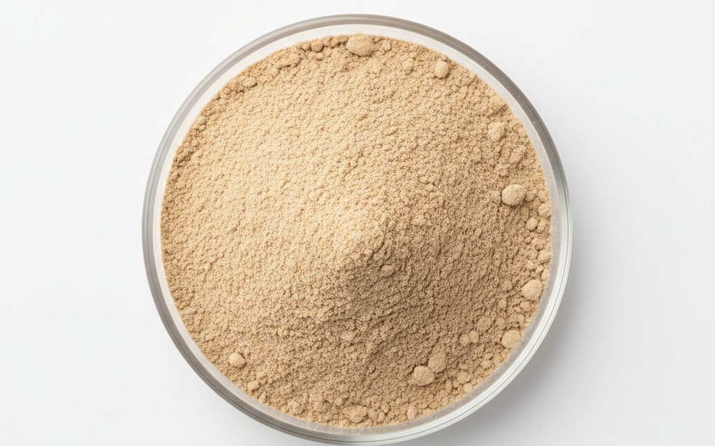 Yeast Hydrolysate / Yeast Cell Wall — a light tan to brown, free-flowing powder with a savory, yeasty aroma, appearing as a fine, organic particulate matter, studio product photograph
